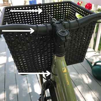 Basket attached to bicycle handlebar using zip ties and bungee cord.