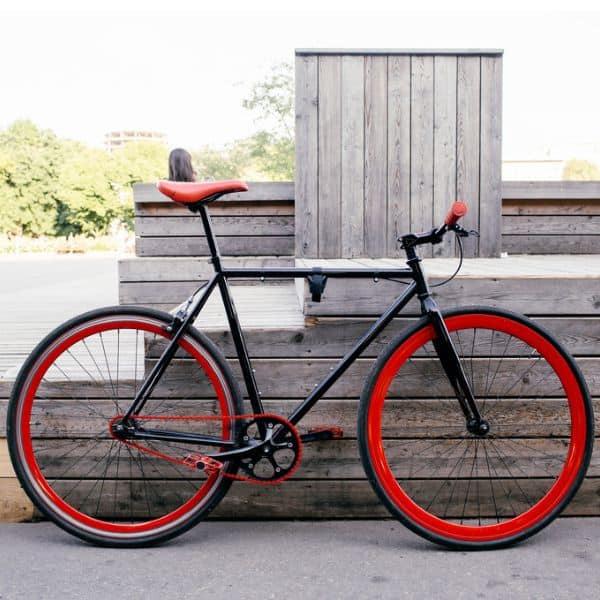 Black hybrid bicycle with flat handlebars and red rims